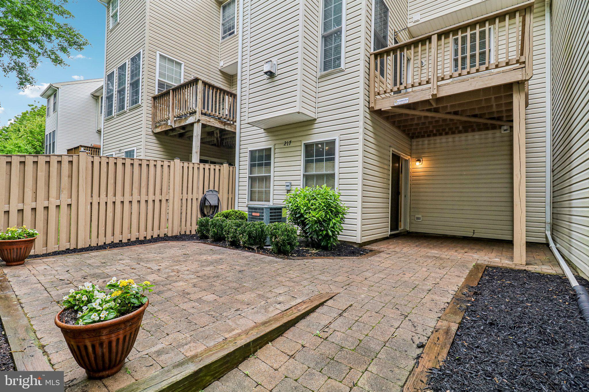 217 Braxton Way, Unit 217 Edgewater, MD 21037 - Photo 23 of 27 a view of a house with a flower plants next to a road