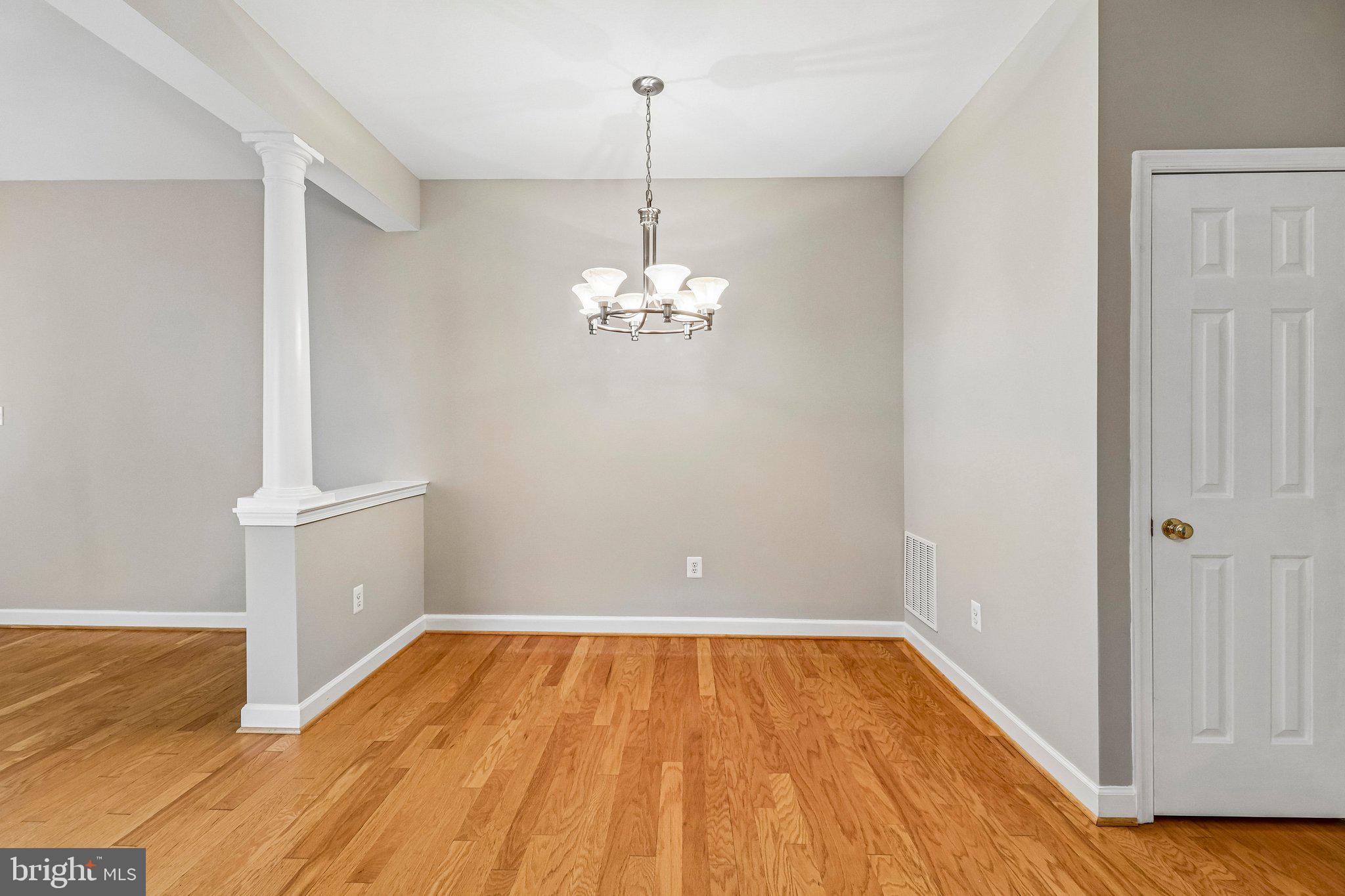 217 Braxton Way, Unit 217 Edgewater, MD 21037 - Photo 5 of 27 wooden floor in an empty room with a window