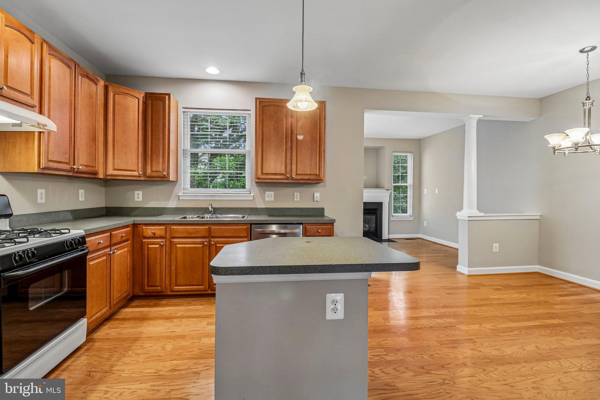 217 Braxton Way, Unit 217 Edgewater, MD 21037 - Photo 6 of 27 a kitchen with stainless steel appliances granite countertop a sink stove and refrigerator