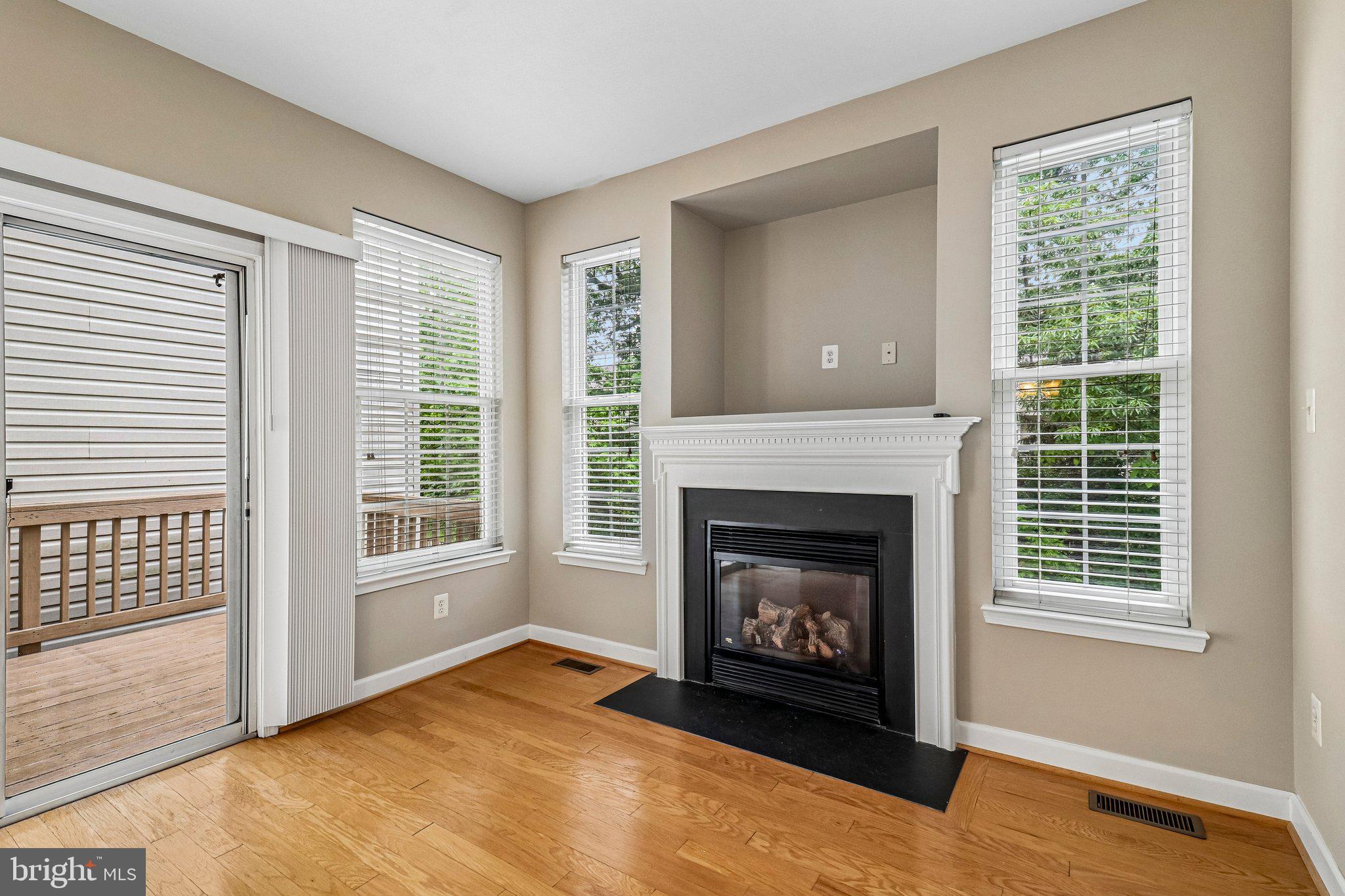 217 Braxton Way, Unit 217 Edgewater, MD 21037 - Photo 9 of 27 a living room with a fireplace and a window