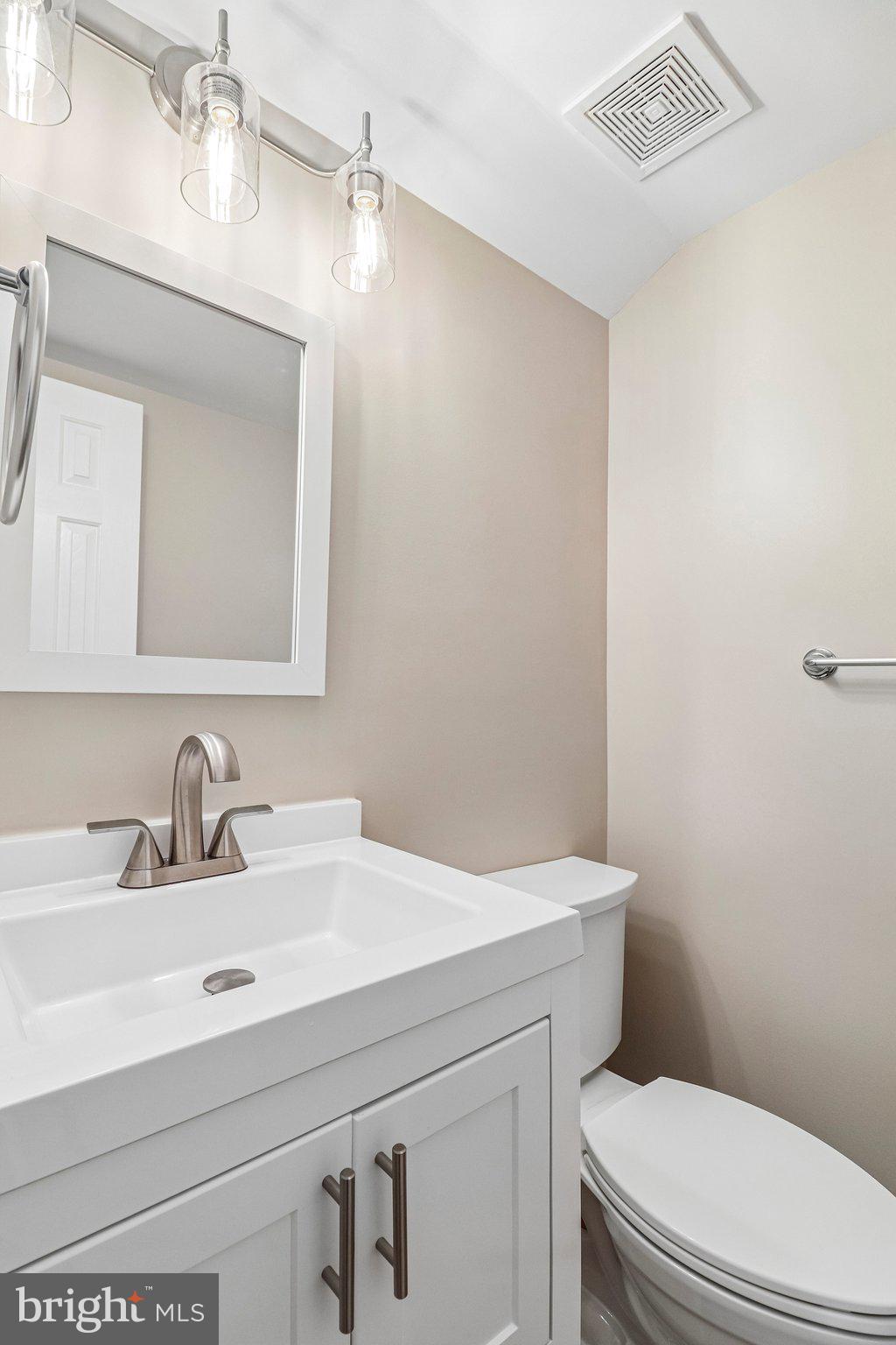 217 Braxton Way, Unit 217 Edgewater, MD 21037 - Photo 10 of 27 a bathroom with a sink a toilet and mirror