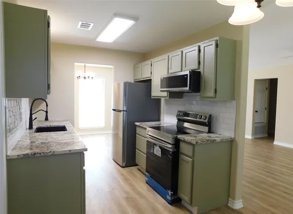 a room with a walk in closet and wooden floor