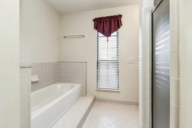 a bathroom with a bathtub and shower