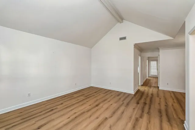 a view of a room with wooden floor
