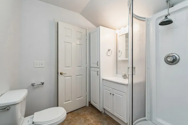 a bathroom with a toilet a sink and shower
