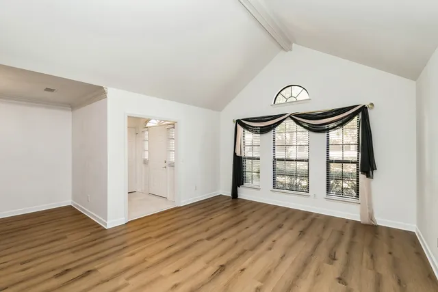 a view of an empty room and wooden floor