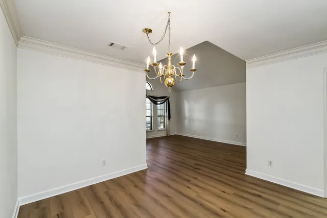 a view of a room with wooden floor