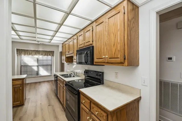 a kitchen with stainless steel appliances granite countertop a stove and a refrigerator