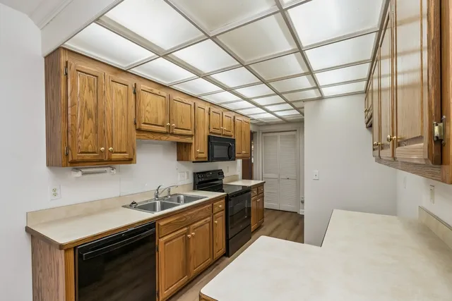 a kitchen with stainless steel appliances granite countertop a sink a stove and a microwave oven