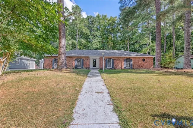 a view of house with outdoor space and garden