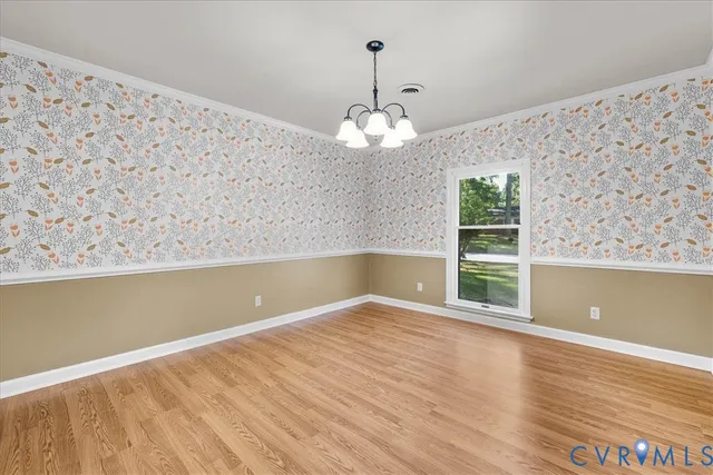a view of wooden floor and windows in a room