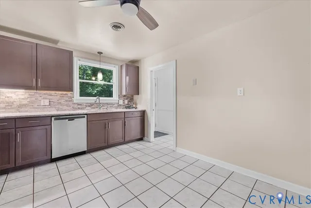 a kitchen with a sink window and cabinets