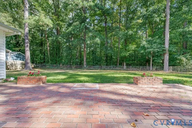 a wooden house with a yard and large trees