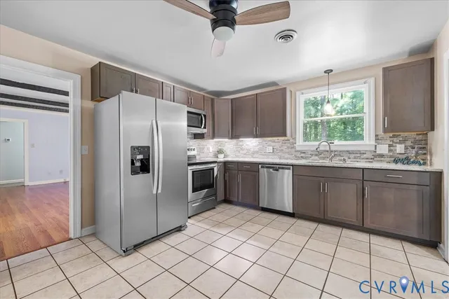 a kitchen with stainless steel appliances a refrigerator sink and microwave