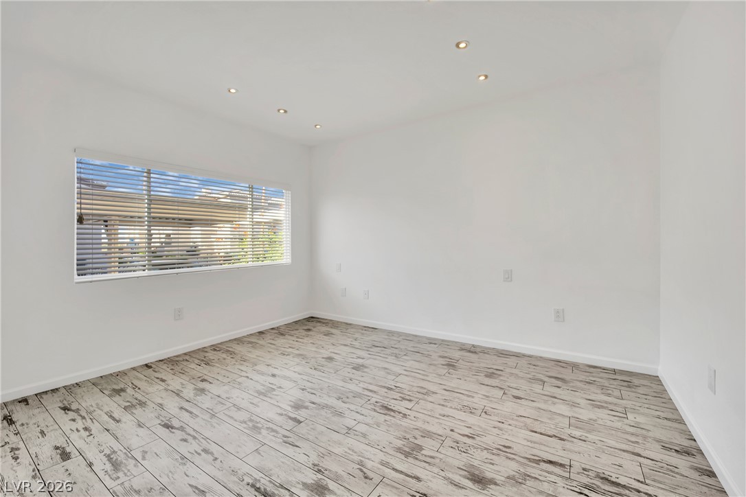 8725 West Flamingo Road, Unit 110 Las Vegas, NV 89147 - Photo 10 of 30 Recessed lighting illuminates this versatile room featuring durable wood-look flooring and a wide window.
