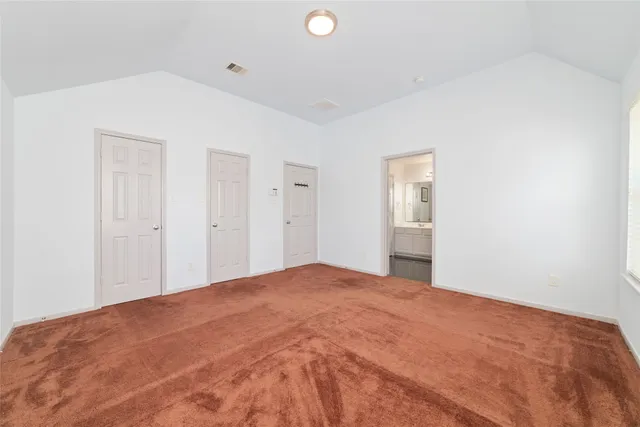 a view of a big room with closet and windows
