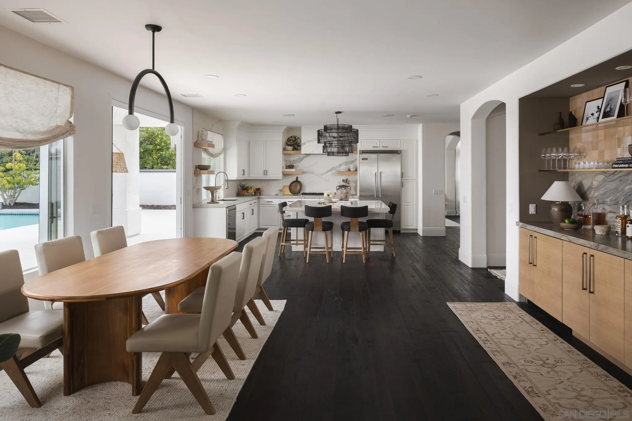 12256 Berea Court Poway, CA 92064 - Photo 6 of 23 a dining room with wooden floor a chandelier a wooden table and chairs