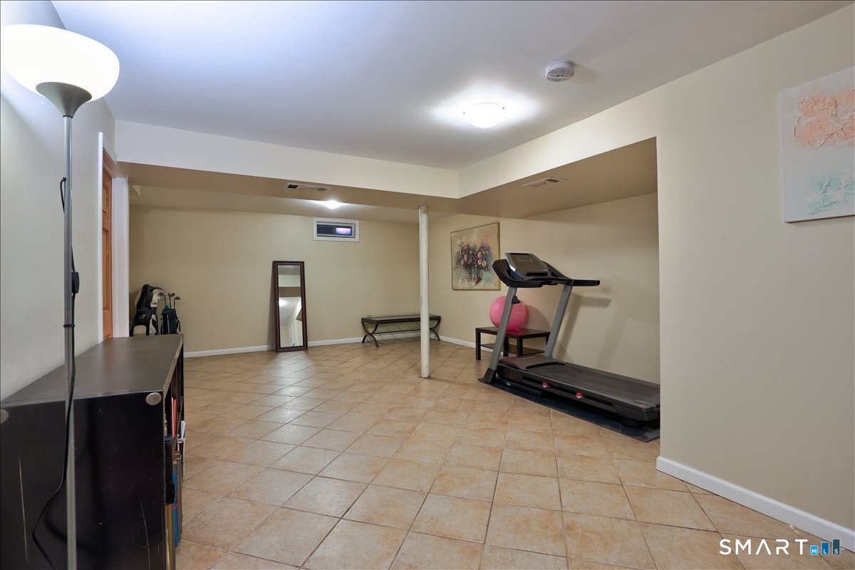 827 Oronoke Road, Unit 51 Waterbury, CT 06708 - Photo 15 of 24 Finished basement. Stairs on the left; spacious and versatile for a variety of uses.