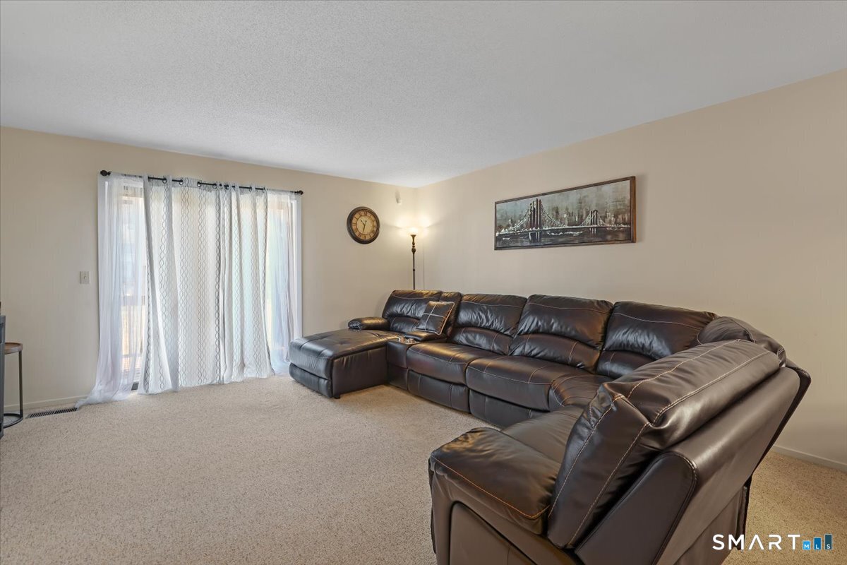 827 Oronoke Road, Unit 51 Waterbury, CT 06708 - Photo 18 of 24 Spacious living room, a deck off of it.