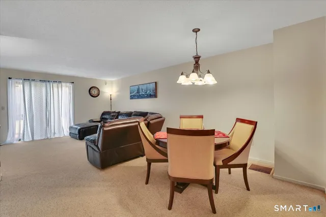 a dining room with furniture and window
