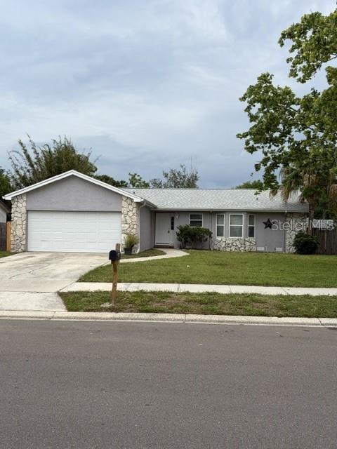 610 Kirkland Circle Dunedin, FL 34698 - Photo 1 of 28 a view of house with outdoor space and parking