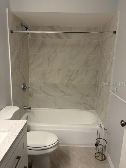 610 Kirkland Circle Dunedin, FL 34698 - Photo 14 of 28 a bathroom with a granite countertop bathtub shower sink vanity and toilet