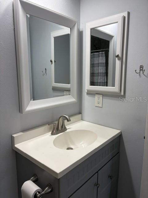 610 Kirkland Circle Dunedin, FL 34698 - Photo 17 of 28 a bathroom with a sink and a mirror