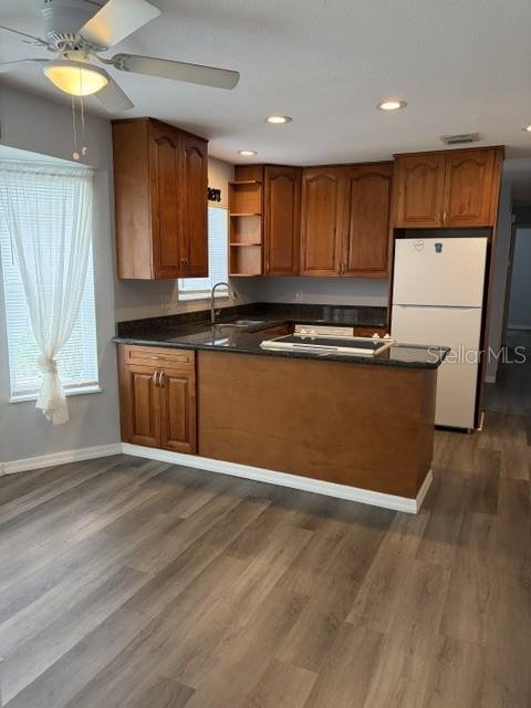 610 Kirkland Circle Dunedin, FL 34698 - Photo 19 of 28 a view of kitchen with wooden floor and electronic appliances