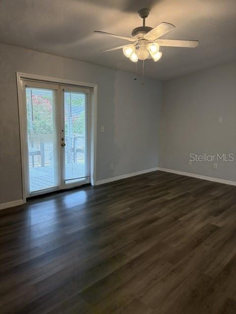 610 Kirkland Circle Dunedin, FL 34698 - Photo 2 of 28 a view of an empty room with window chandelier fan and wooden floor