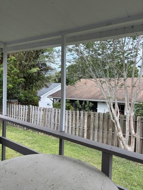 610 Kirkland Circle Dunedin, FL 34698 - Photo 24 of 28 a view of a deck with a floor to ceiling window and a yard