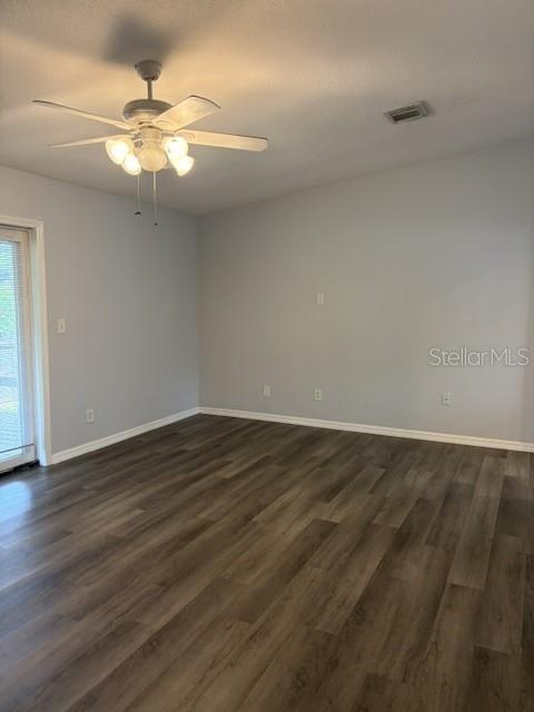 610 Kirkland Circle Dunedin, FL 34698 - Photo 3 of 28 a view of an empty room with wooden floor and a window