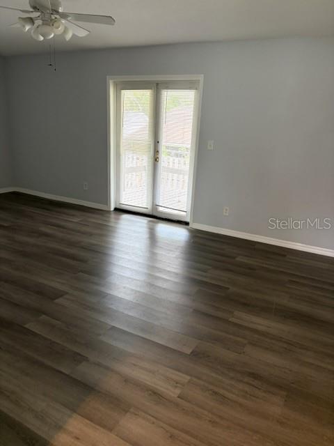610 Kirkland Circle Dunedin, FL 34698 - Photo 4 of 28 a view of an empty room with wooden floor and a window