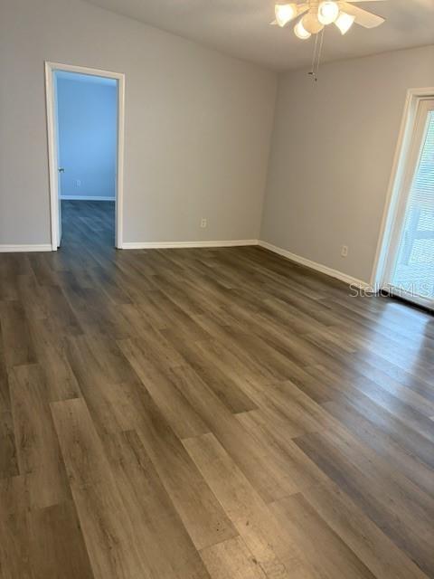 610 Kirkland Circle Dunedin, FL 34698 - Photo 5 of 28 a view of an empty room with wooden floor and a window