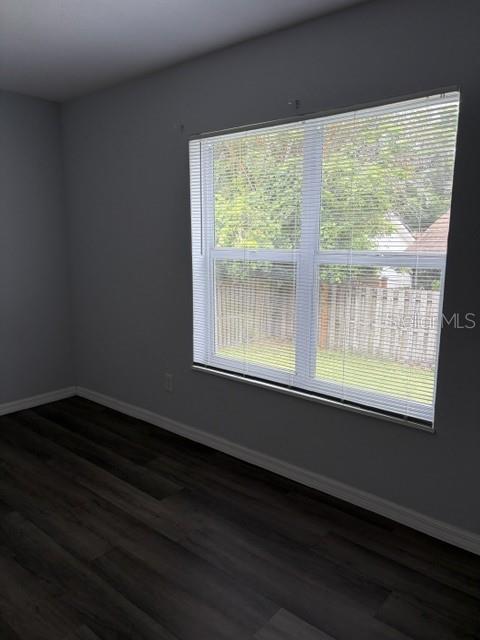 610 Kirkland Circle Dunedin, FL 34698 - Photo 9 of 28 a view of an empty room with wooden floor and a window