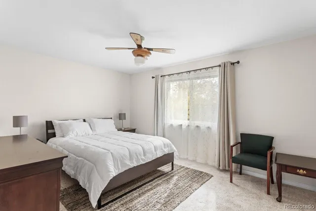 a bedroom with a bed a table and chair