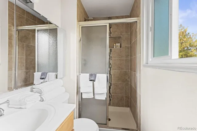 a bathroom with a bathtub shower and toilet