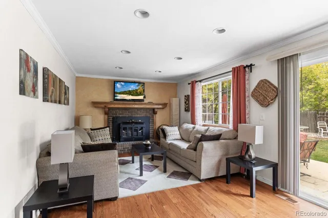 a living room with furniture a fireplace and a table