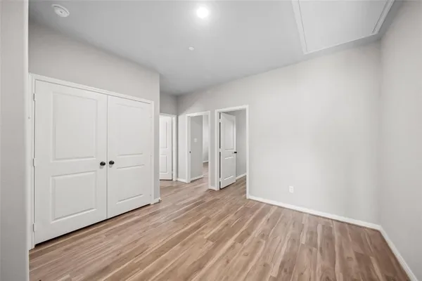 a view of an empty room and wooden floor