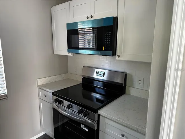 a kitchen with a stove and a microwave