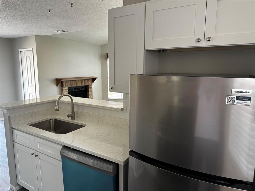 652 Roaring Drive, Unit 234 Altamonte Springs, FL 32714 - Photo 16 of 39 a kitchen with a refrigerator and a sink