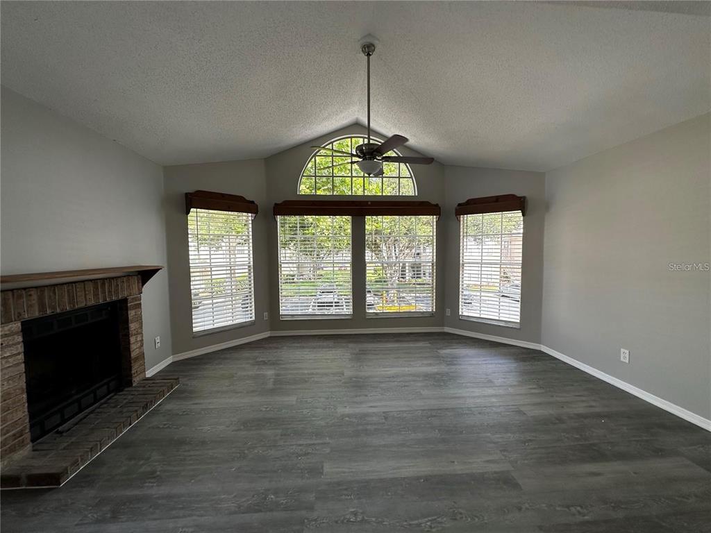 652 Roaring Drive, Unit 234 Altamonte Springs, FL 32714 - Photo 18 of 39 wooden floor fireplace and windows in an empty room