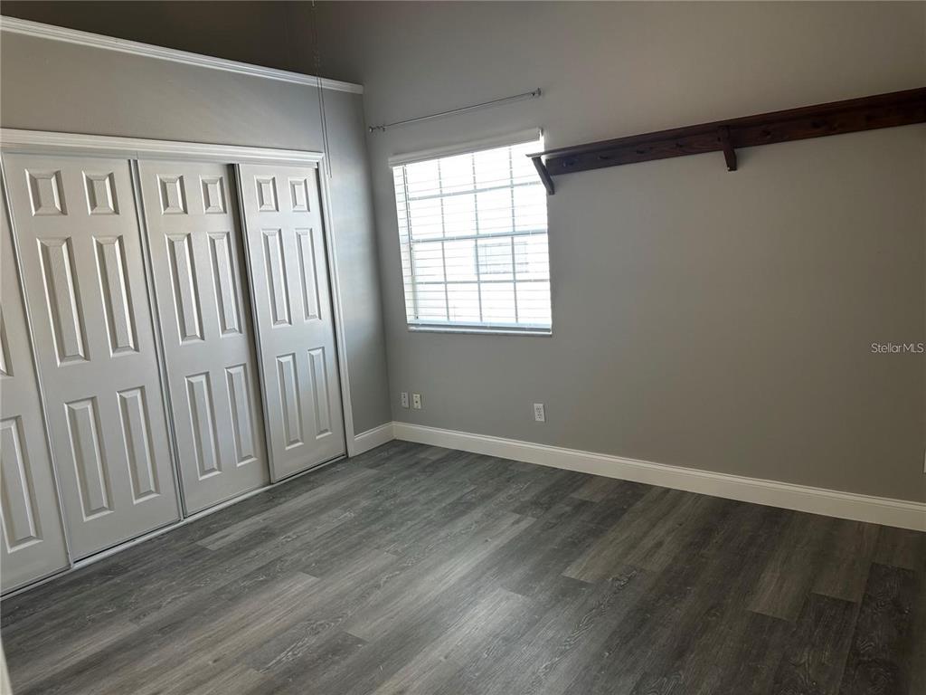 652 Roaring Drive, Unit 234 Altamonte Springs, FL 32714 - Photo 20 of 39 a view of an empty room with wooden floor and a window