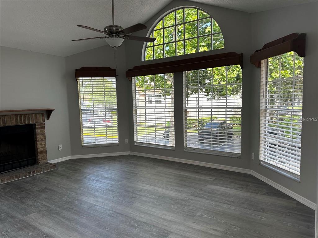 652 Roaring Drive, Unit 234 Altamonte Springs, FL 32714 - Photo 2 of 39 a view of an empty room with a window and wooden floor