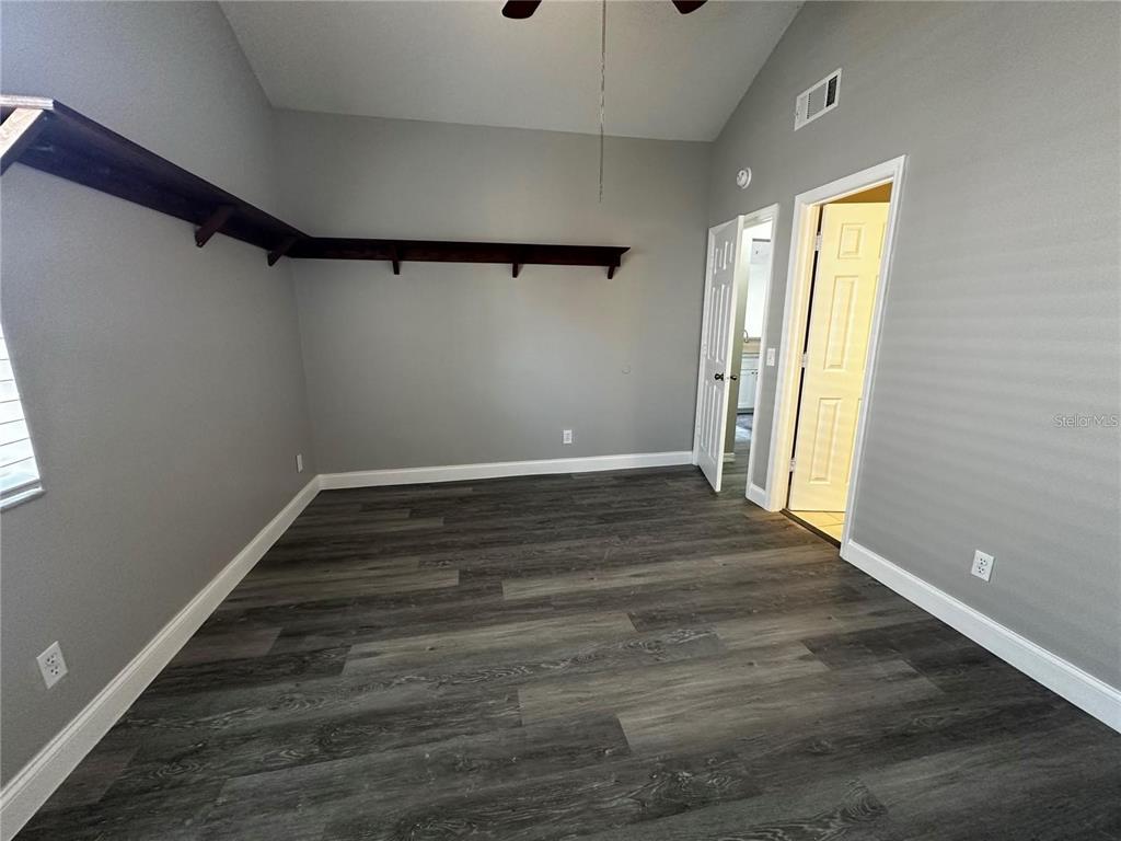 652 Roaring Drive, Unit 234 Altamonte Springs, FL 32714 - Photo 21 of 39 a view of an empty room with wooden floor and a window