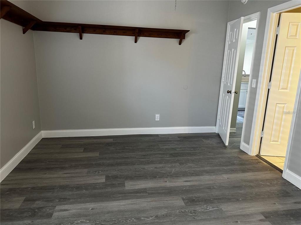 652 Roaring Drive, Unit 234 Altamonte Springs, FL 32714 - Photo 22 of 39 a view of an empty room with wooden floor and a window