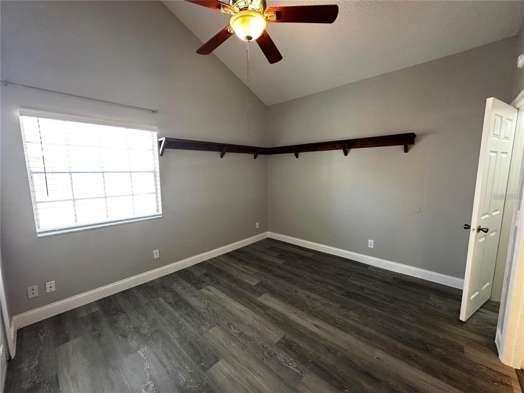 652 Roaring Drive, Unit 234 Altamonte Springs, FL 32714 - Photo 23 of 39 a view of an empty room with wooden floor and a window