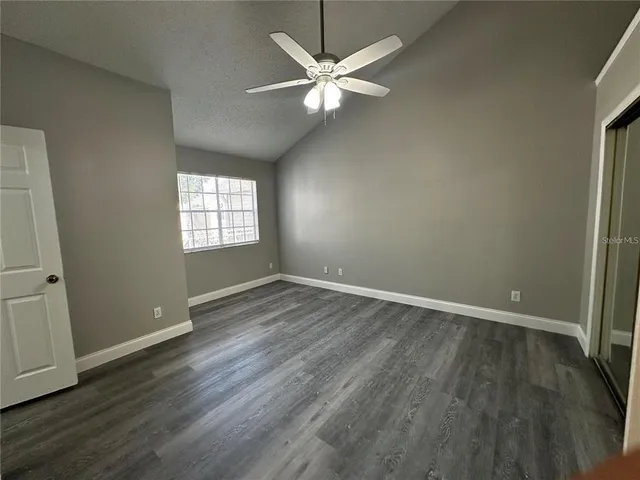 a view of livingroom with window ceiling fan and hardwood floor