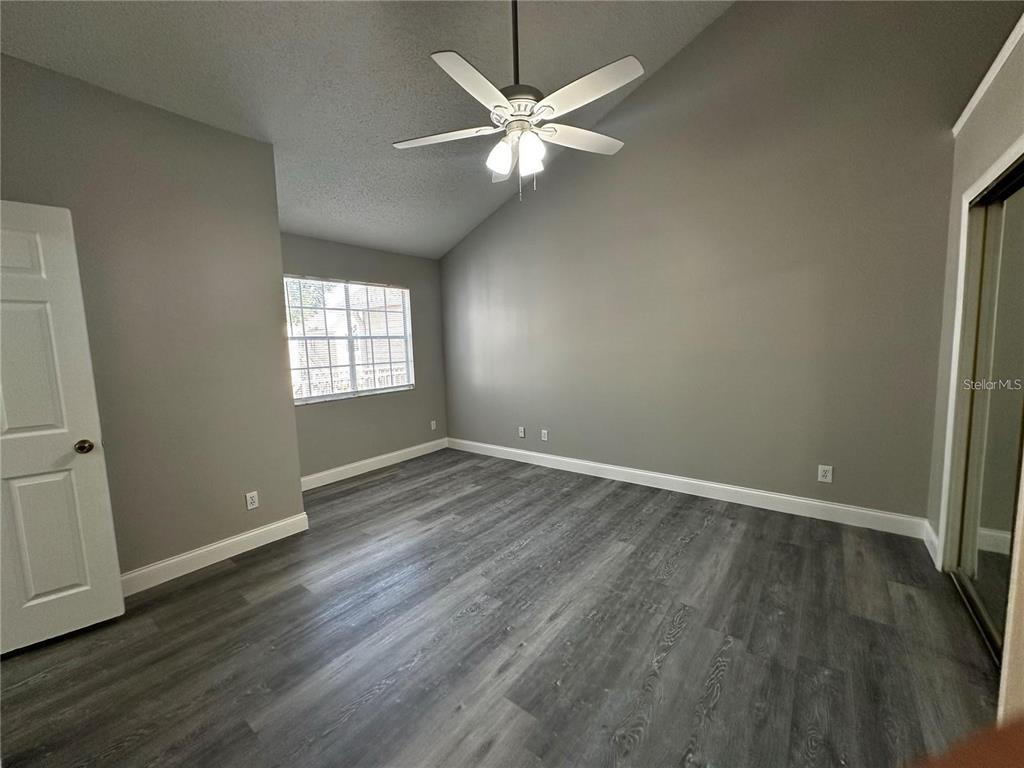 652 Roaring Drive, Unit 234 Altamonte Springs, FL 32714 - Photo 30 of 39 an empty room with wooden floor and windows