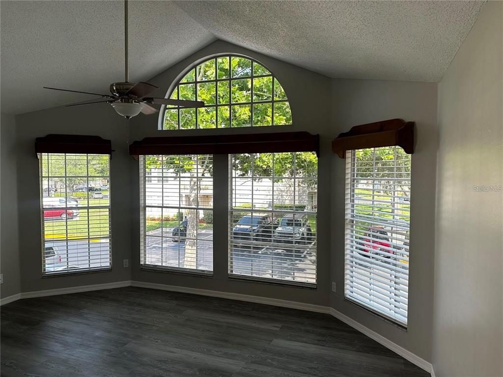 652 Roaring Drive, Unit 234 Altamonte Springs, FL 32714 - Photo 3 of 39 a view of an empty room with wooden floor and a window