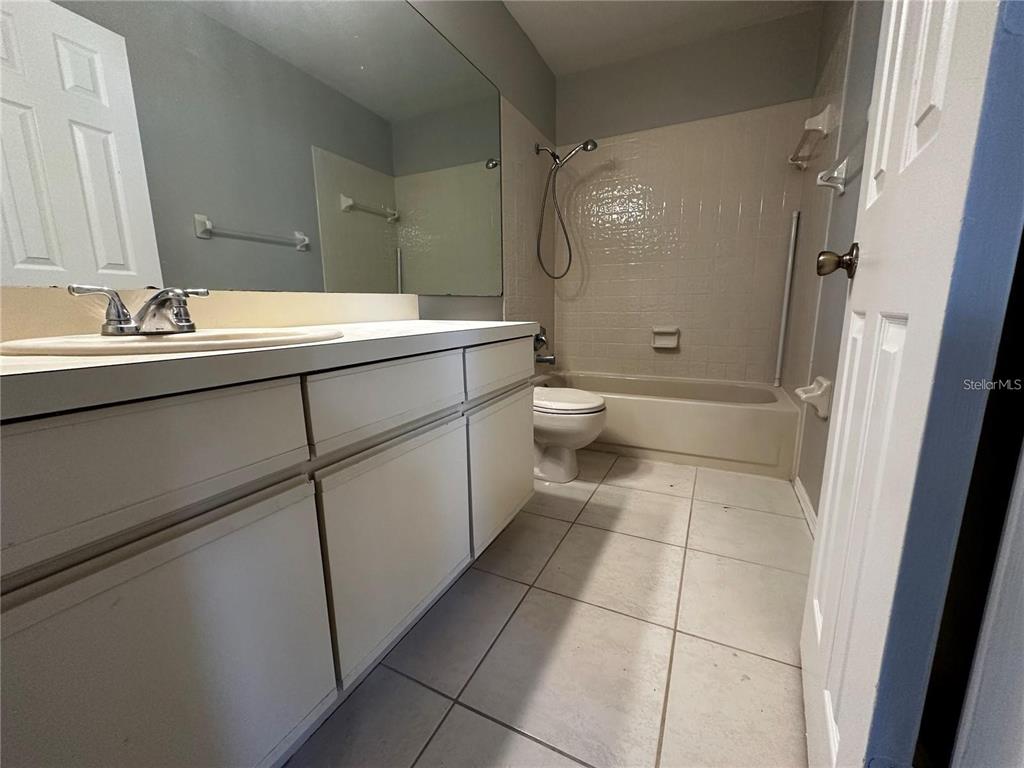 652 Roaring Drive, Unit 234 Altamonte Springs, FL 32714 - Photo 33 of 39 a bathroom with a double vanity sink toilet and shower